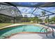 Refreshing kidney-shaped pool with screened enclosure at 1573 Faraday St, Port Charlotte, FL 33952