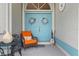 Front porch with blue doors, orange chair, and wreaths at 16253 Cape Horn Blvd, Punta Gorda, FL 33955