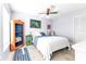 Bedroom with a queen-size bed, ceiling fan, and orange bookshelf at 1640 Montia Ct, Punta Gorda, FL 33950