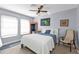 Bedroom with a queen-size bed, ceiling fan, and mid-century chair at 1640 Montia Ct, Punta Gorda, FL 33950