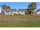 Light-green home with landscaped yard and decorative wall at 1640 Montia Ct, Punta Gorda, FL 33950