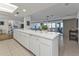 Open concept kitchen with white cabinetry and breakfast bar at 1640 Montia Ct, Punta Gorda, FL 33950