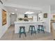 Kitchen boasts white cabinets, teal stools, and an open layout at 1640 Montia Ct, Punta Gorda, FL 33950