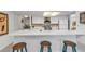 White kitchen with breakfast bar and teal stools at 1640 Montia Ct, Punta Gorda, FL 33950