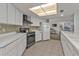 Kitchen with white cabinets, black appliances, and mosaic backsplash at 1640 Montia Ct, Punta Gorda, FL 33950