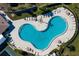 Relaxing kidney-shaped community pool with plenty of lounge chairs at 175 Kings Hwy # 738, Punta Gorda, FL 33983