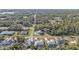 Aerial view of neighborhood, featuring houses, roads, and lush greenery at 18266 Grace Ave, Port Charlotte, FL 33948