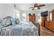 Spacious bedroom with a king-size bed and ceiling fan at 18266 Grace Ave, Port Charlotte, FL 33948