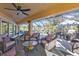 Relaxing screened patio with seating area and view of the pool at 18266 Grace Ave, Port Charlotte, FL 33948