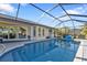 Relaxing screened pool area with tiled deck at 18266 Grace Ave, Port Charlotte, FL 33948