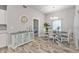 Bright dining room with chandelier, wood table, and white chairs at 18322 Garman Ave, Port Charlotte, FL 33948