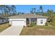 Single-story home with a two-car garage and a screened porch at 18322 Garman Ave, Port Charlotte, FL 33948