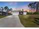 Modern single-story house with driveway, garage, and landscaped yard at 18322 Garman Ave, Port Charlotte, FL 33948