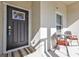 Inviting front porch with a dark-colored door and small bistro set at 18322 Garman Ave, Port Charlotte, FL 33948