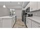 Modern kitchen featuring white cabinets, quartz countertops, and stainless steel appliances at 18322 Garman Ave, Port Charlotte, FL 33948