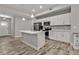 Modern kitchen featuring white cabinets, stainless steel appliances, and an island at 18322 Garman Ave, Port Charlotte, FL 33948