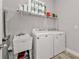 Laundry room with washer, dryer, utility sink, and storage shelves at 18322 Garman Ave, Port Charlotte, FL 33948