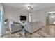 Bright living room with gray sofas and access to the kitchen at 18322 Garman Ave, Port Charlotte, FL 33948