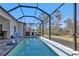 Relaxing screened pool with a basketball hoop at 18322 Garman Ave, Port Charlotte, FL 33948