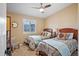 Bedroom with two twin-size beds and ceiling fan at 1839 Settlers Dr # B-6, Nokomis, FL 34275