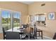 Dining area with a black table and chairs, kitchen view at 1839 Settlers Dr # B-6, Nokomis, FL 34275