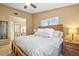 Main bedroom with king-size bed and ensuite bathroom at 1839 Settlers Dr # B-6, Nokomis, FL 34275