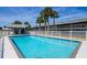 Community pool with patio and fenced area at 1839 Settlers Dr # B-6, Nokomis, FL 34275