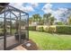 Landscaped backyard with screened patio at 19119 Mangieri St, Venice, FL 34293