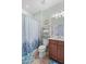 Bathroom with shower/tub combo and wood vanity at 19119 Mangieri St, Venice, FL 34293