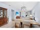 Bright dining room with a wooden table and chairs near the kitchen at 19119 Mangieri St, Venice, FL 34293