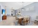 Dining area with a wooden table and chairs, open to the living room at 19119 Mangieri St, Venice, FL 34293