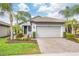 One-story home with a two-car garage and landscaped front yard at 19119 Mangieri St, Venice, FL 34293