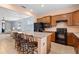 Island kitchen with granite countertops and black appliances at 19119 Mangieri St, Venice, FL 34293