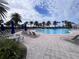 Resort-style pool with blue umbrellas and lounge chairs at 19119 Mangieri St, Venice, FL 34293