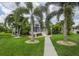 Walkway to screened patio, surrounded by tropical landscaping at 195 Bayshore Ct, Punta Gorda, FL 33950