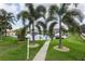 Landscaped walkway to private canal access with boat slips at 195 Bayshore Ct, Punta Gorda, FL 33950