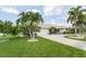 Single-Gathering home with lush landscaping and driveway at 195 Bayshore Ct, Punta Gorda, FL 33950