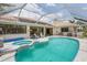 Relaxing pool and spa area with a covered patio at 195 Bayshore Ct, Punta Gorda, FL 33950