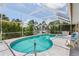 Inviting kidney-shaped pool with screened enclosure at 195 Bayshore Ct, Punta Gorda, FL 33950