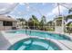 Inviting pool and spa with a screened enclosure at 195 Bayshore Ct, Punta Gorda, FL 33950