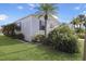 Side view of a manufactured home with manicured lawn at 2100 Kings Hwy # 100, Port Charlotte, FL 33980