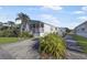 Charming single-wide home with covered porch and landscaping at 2100 Kings Hwy # 100, Port Charlotte, FL 33980