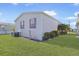 Single-wide manufactured home with red shutters and a well-maintained lawn at 2100 Kings Hwy # 100, Port Charlotte, FL 33980