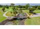 Elevated view of a peaceful walking bridge over a calm stream at 2100 Kings Hwy # 100, Port Charlotte, FL 33980