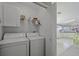 Convenient laundry room with washer, dryer, and kitchen view at 2100 Kings Hwy # 100, Port Charlotte, FL 33980