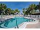 Relaxing kidney-shaped pool with lounge chairs at 2100 Kings Hwy # 100, Port Charlotte, FL 33980