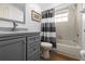 Guest bathroom with grey vanity and a tub shower combo at 2210 Bengal Ct, Punta Gorda, FL 33983