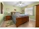 Guest bedroom with light green walls and wooden bed frame at 2210 Bengal Ct, Punta Gorda, FL 33983