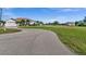 House exterior view with circular driveway and large yard at 2210 Bengal Ct, Punta Gorda, FL 33983