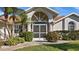 House exterior featuring a screened entryway and lush landscaping at 2210 Bengal Ct, Punta Gorda, FL 33983